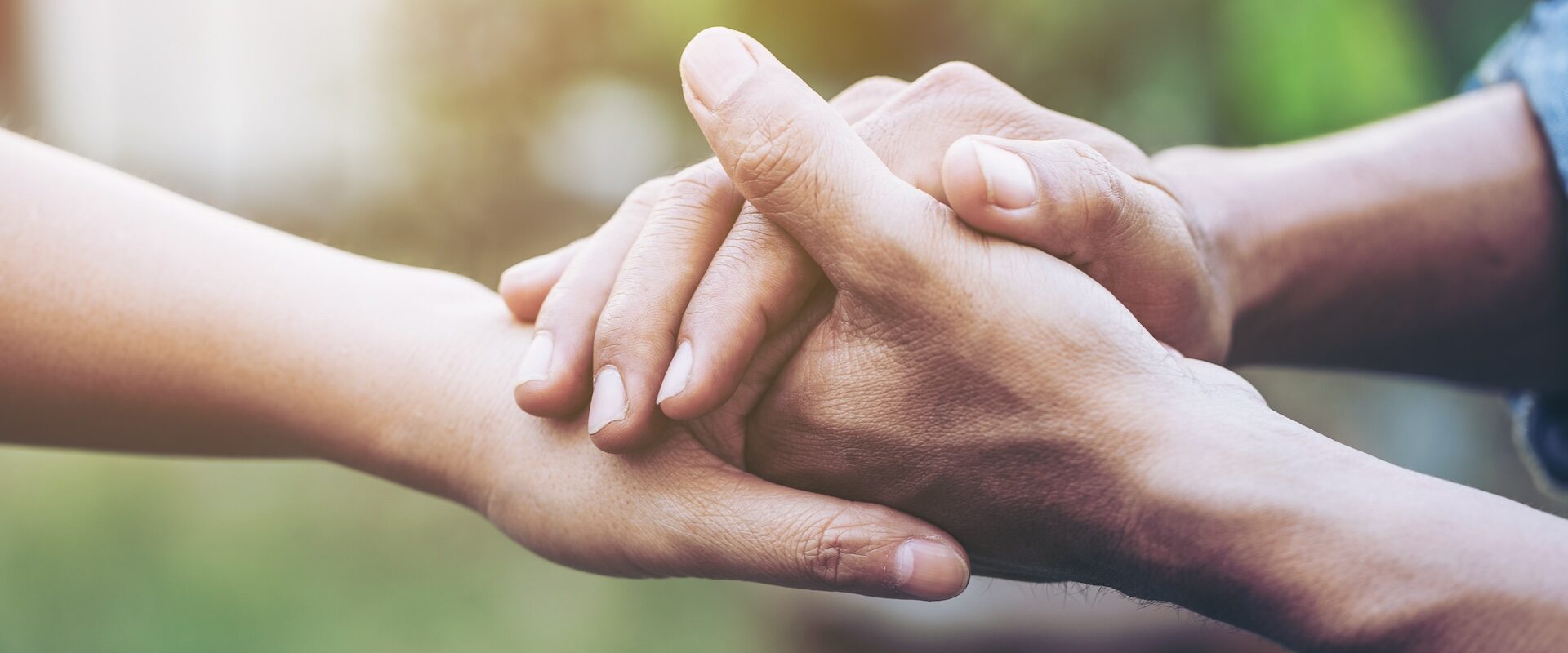 Two young lovers holding hands with blur backgroung hands helping